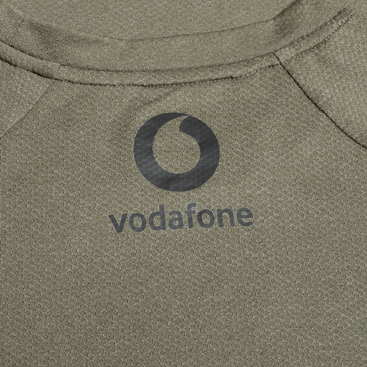 Close-up of the Ireland 25/26 Autumn Internationals Elite Training Tee by Canterbury in khaki, featuring the black Vodafone logo and Vapodri fabric for enhanced performance.