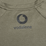 Close-up of the Ireland 25/26 Autumn Internationals Elite Training Tee by Canterbury in khaki, featuring the black Vodafone logo and Vapodri fabric for enhanced performance.