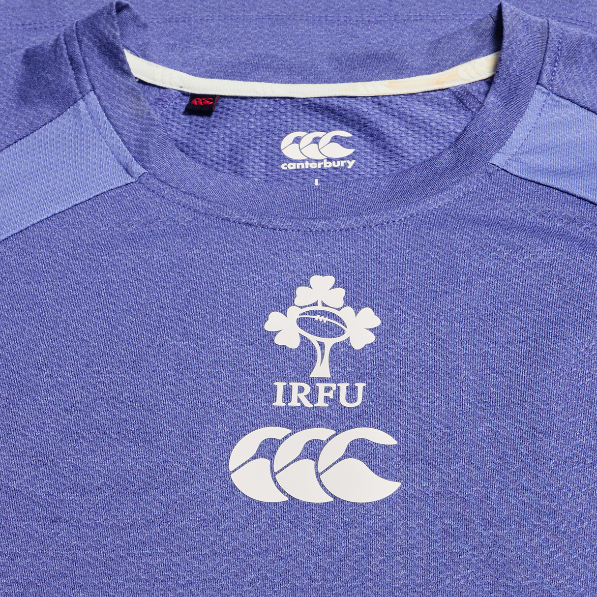Close-up of the Ireland 25/26 Six Nations Elite Training Tee by Canterbury, showing the IRFU logo, rugby ball motif, and Canterbury branding on the chest.