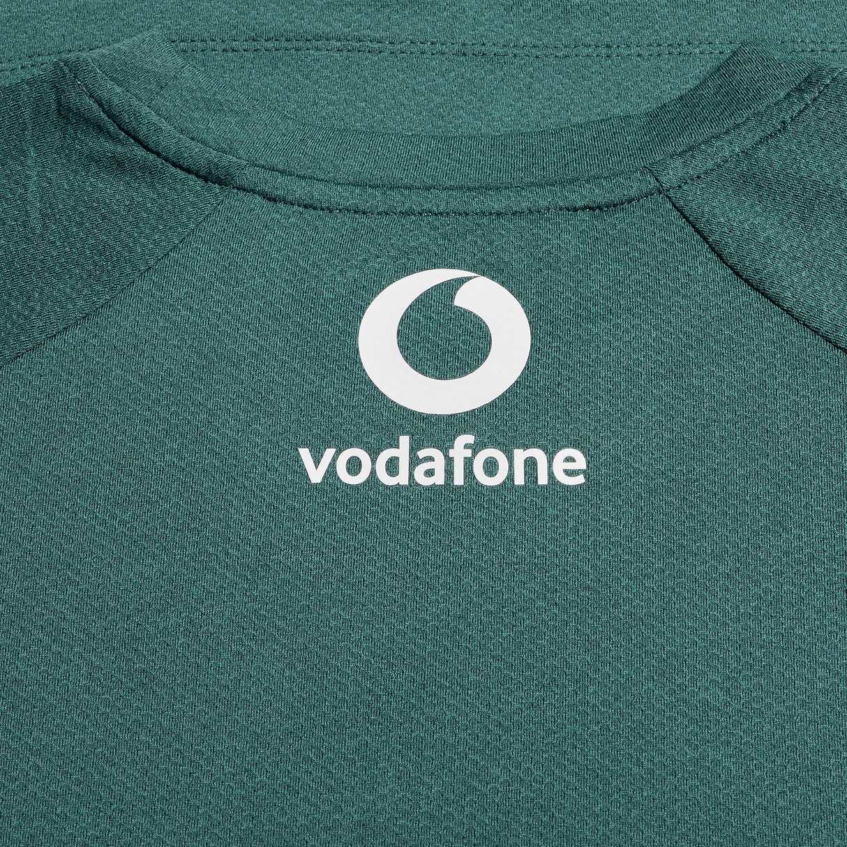 Close-up of the Ireland 25/26 Six Nations Elite Training Tee by Canterbury in green, featuring the white Vodafone logo and text on the upper back.