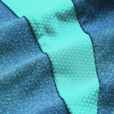 Close-up of textured fabric with alternating teal and turquoise diagonal stripes, mirroring the premium materials in the Canterbury Ireland 26/27 Summer Tour Elite Training Tee.