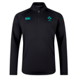 The Ireland 25 Elite First Layer by Canterbury is a black long-sleeve athletic training top with a quarter-zip, VapoDri technology, and features the Canterbury logo and IRFU emblem on the chest.