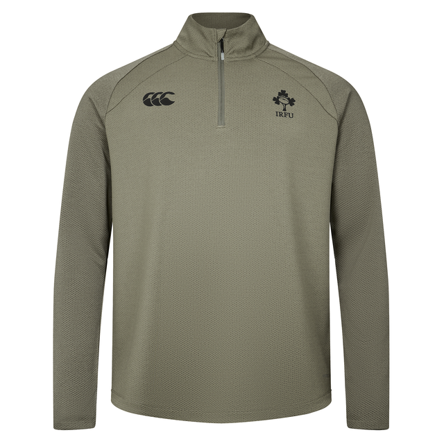 The Ireland 25/26 Elite First Layer 1/4 Zip by Canterbury features long sleeves and IRFU and Canterbury logos on the chest, shown in light olive on a plain white background.