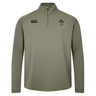 The Ireland 25/26 Elite First Layer 1/4 Zip by Canterbury features long sleeves and IRFU and Canterbury logos on the chest, shown in light olive on a plain white background.