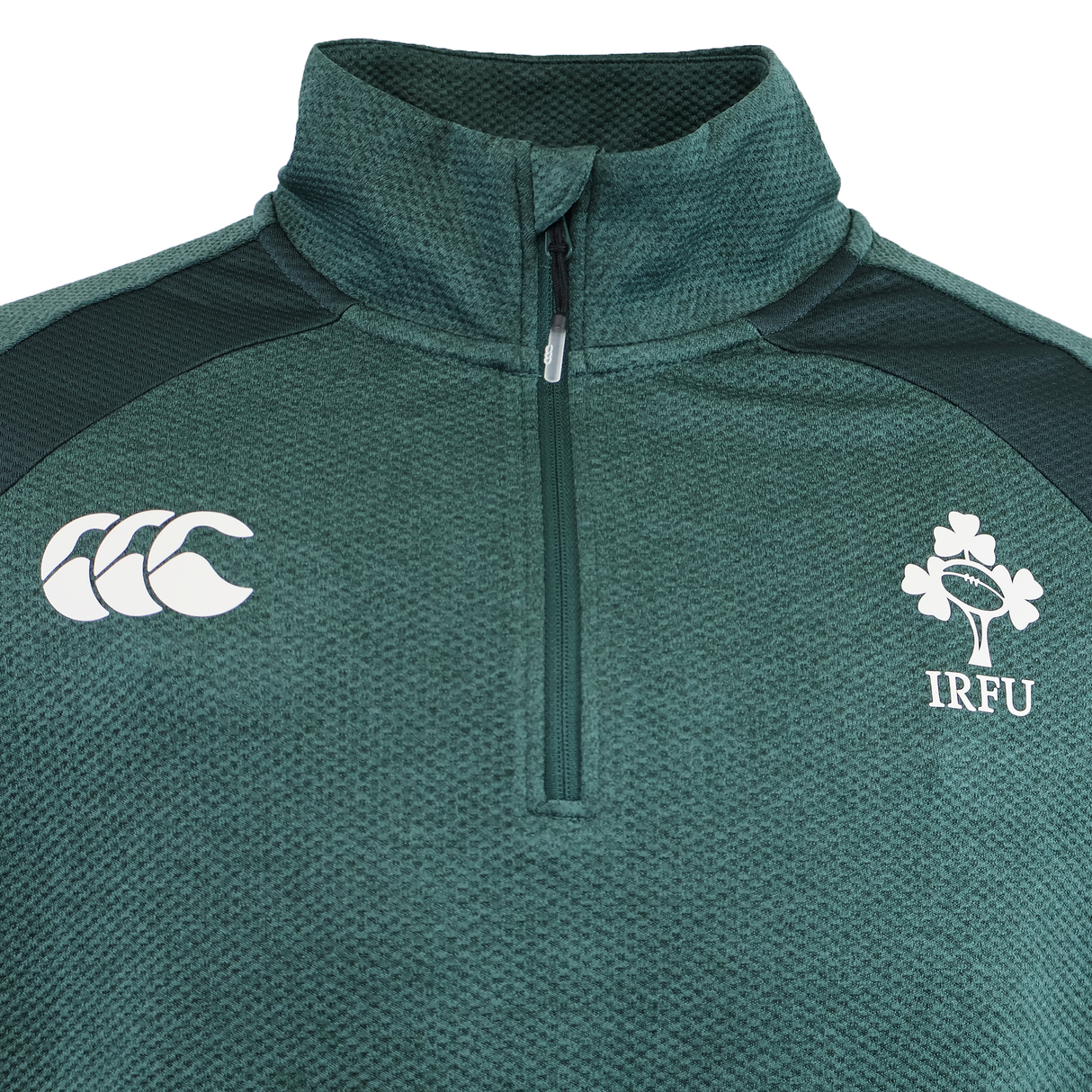 Show your support in the Ireland 25/26 Elite First Layer 1/4 Zip by Canterbury, featuring the iconic Canterbury logo on the left and the IRFU shamrock crest on the right.