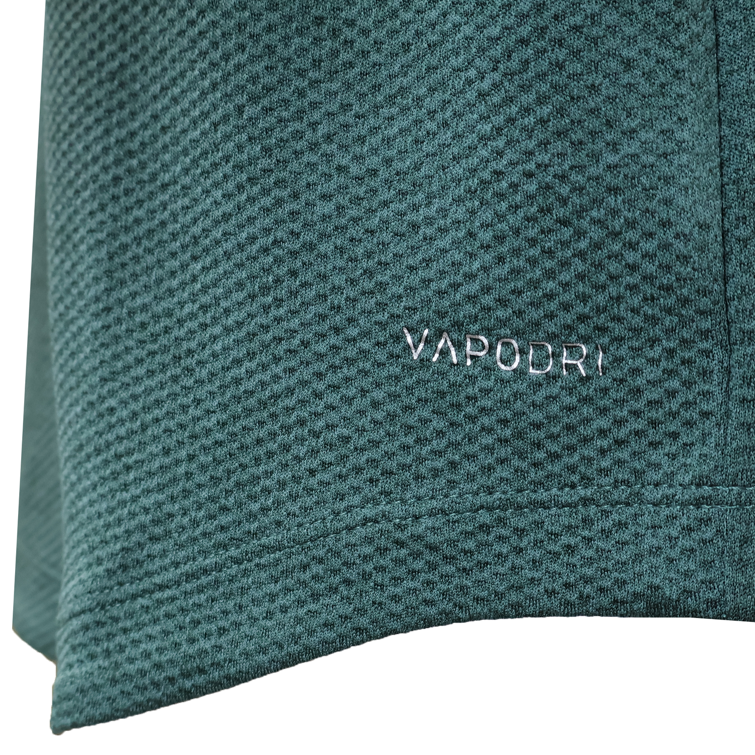 Close-up of green textured fabric from the Ireland 25/26 Elite First Layer 1/4 Zip by Canterbury, featuring "VAPODRI" embroidered in white—a signature Canterbury detail on this top.