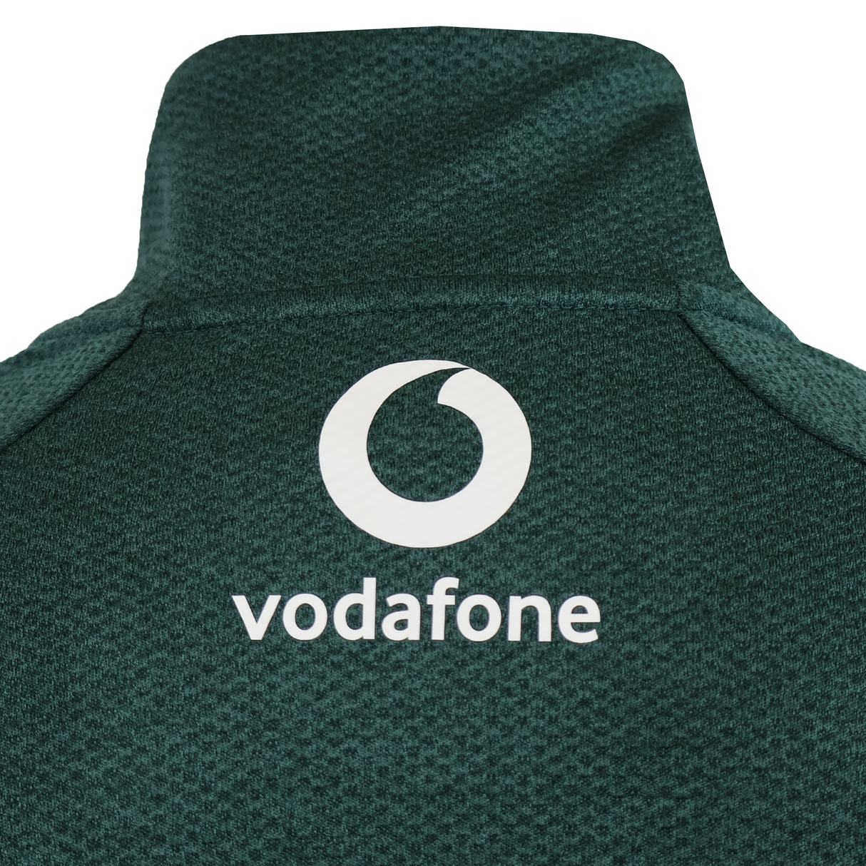 Close-up of the upper back of the green Canterbury Ireland 25/26 Elite First Layer 1/4 Zip, highlighting its textured design and white Vodafone logo.