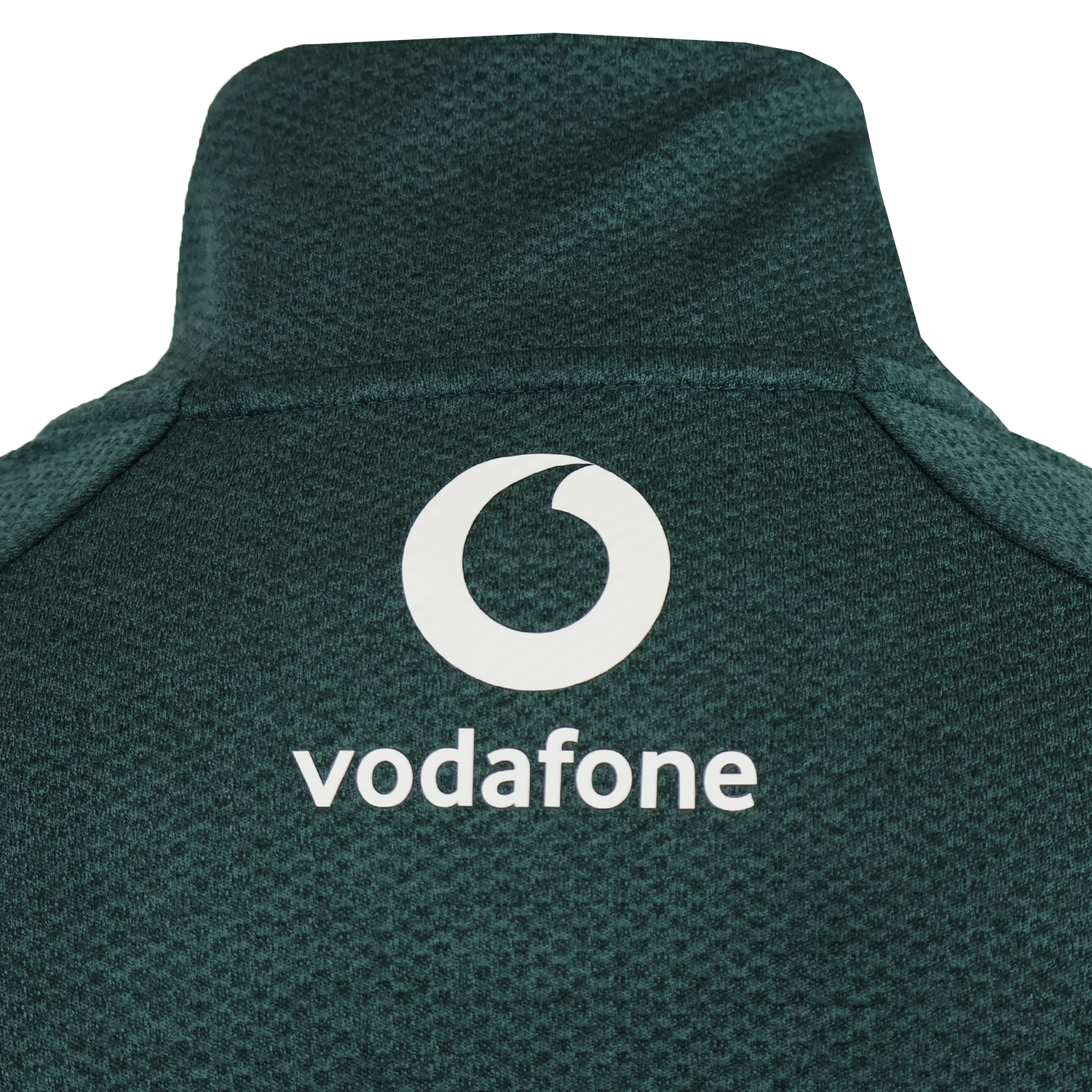 Close-up of the upper back of the green Canterbury Ireland 25/26 Elite First Layer 1/4 Zip, highlighting its textured design and white Vodafone logo.