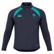 The Ireland 26/27 Summer Tour Elite First Layer by Canterbury is a dark navy quarter-zip athletic top with teal accents, Vapodri tech for comfort, and IRFU and Canterbury logos—crafted for Ireland’s elite summer tour squad.