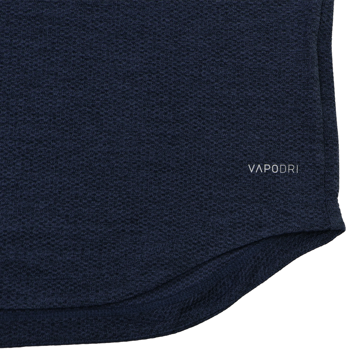 Close-up of the Ireland 26/27 Summer Tour Elite First Layer by Canterbury in navy blue textured fabric featuring Vapodri technology, with "VAPODRI" printed near the hem—a must-have for elite performance.