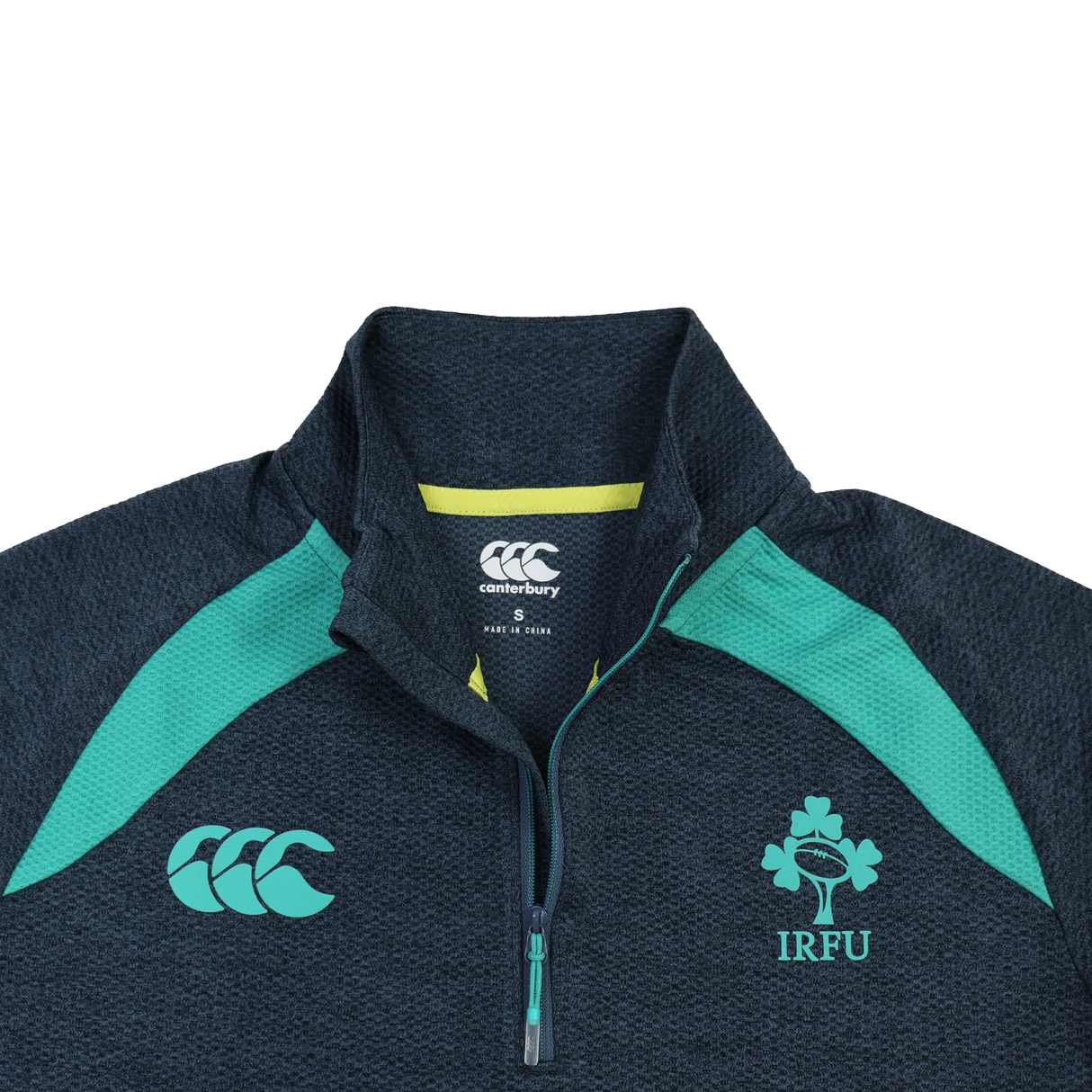 The Ireland 26/27 Summer Tour Elite First Layer by Canterbury is a dark grey lightweight quarter-zip with teal accents, IRFU shamrock and Canterbury logos, and Vapodri tech for comfort—part of the Elite range.