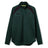 The Ireland 26 Elite First Layer by Canterbury is a dark green, long-sleeve quarter-zip pullover featuring black shoulder accents and chest logos. Crafted from Vapodri fabric for superior moisture management, this top is part of the Canterbury Elite collection and is shown here on a white background.
