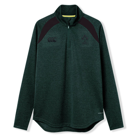 The Ireland 26 Elite First Layer by Canterbury is a dark green, long-sleeve quarter-zip pullover featuring black shoulder accents and chest logos. Crafted from Vapodri fabric for superior moisture management, this top is part of the Canterbury Elite collection and is shown here on a white background.