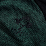 Close-up of the green textured Ireland 26 Elite First Layer by Canterbury, featuring the black embroidered Irish Rugby Football Union (IRFU) shamrock logo and crafted with Canterbury’s Elite Vapodri technology for enhanced comfort.