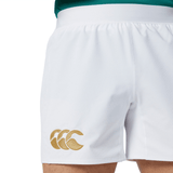 A person is wearing the Ireland 150th Anniversary Home Match Shorts by Canterbury, featuring a gold logo on the left.
