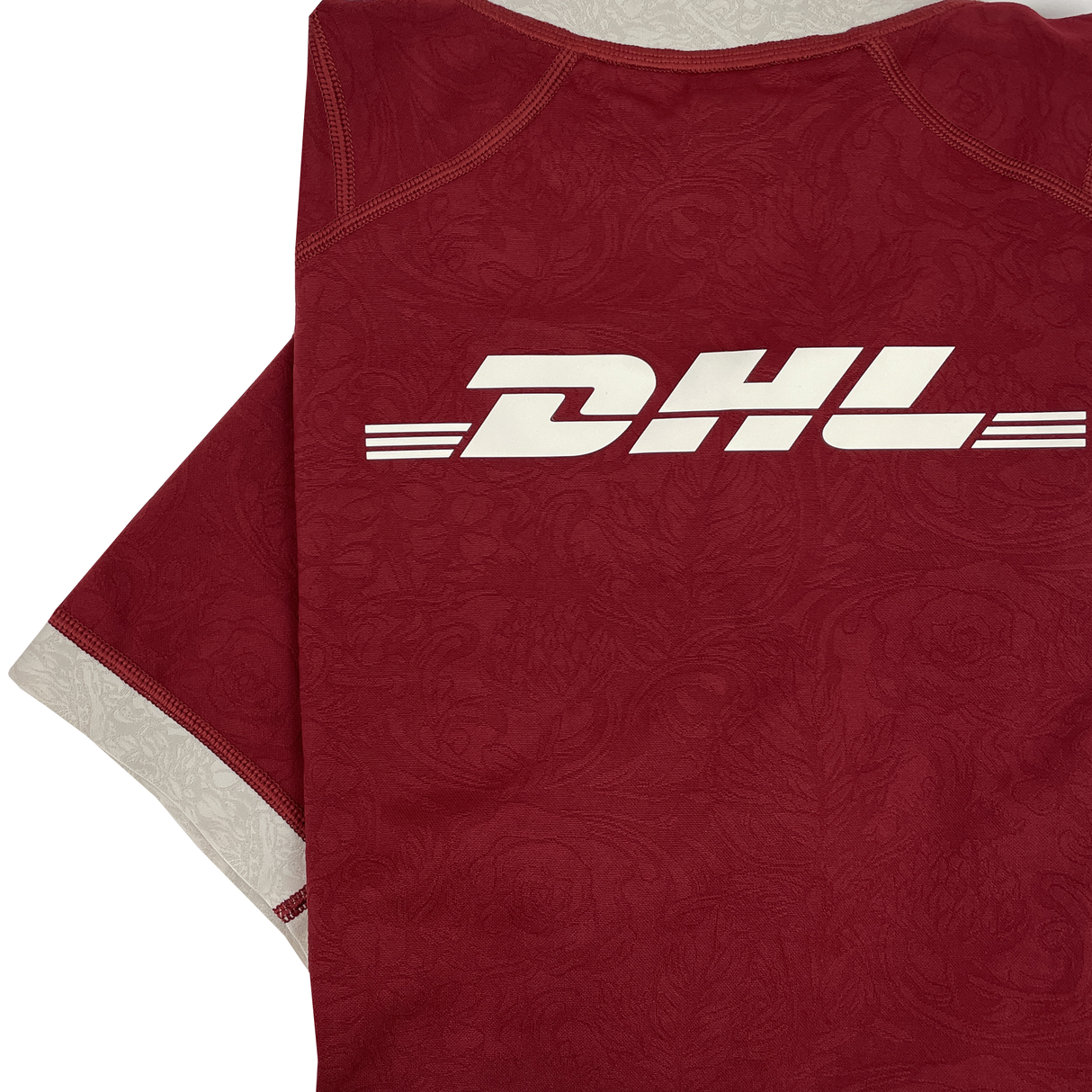 The British & Irish Lions 2025 Players Authentic Jersey by Canterbury sports a subtle floral pattern and prominent white "DHL" logo on the back, echoing the iconic 2025 tour jersey style.