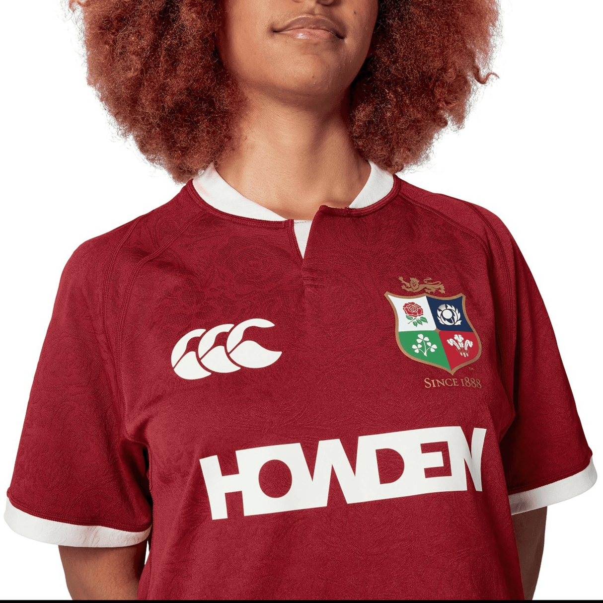 The person is wearing the British & Irish Lions 2025 Players Jersey by Canterbury, featuring logos including the renowned British & Irish Lions crest. Made from moisture-wicking fabric, this replica jersey offers comfort and style for passionate supporters.