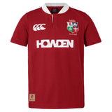 Discover the timeless elegance of the British & Irish Lions 2025 Classic Jersey by Canterbury: a stunning red dahlia rugby top featuring a white collar, adorned with the Canterbury logo, Howden sponsor, and the iconic British & Irish Lions crest.