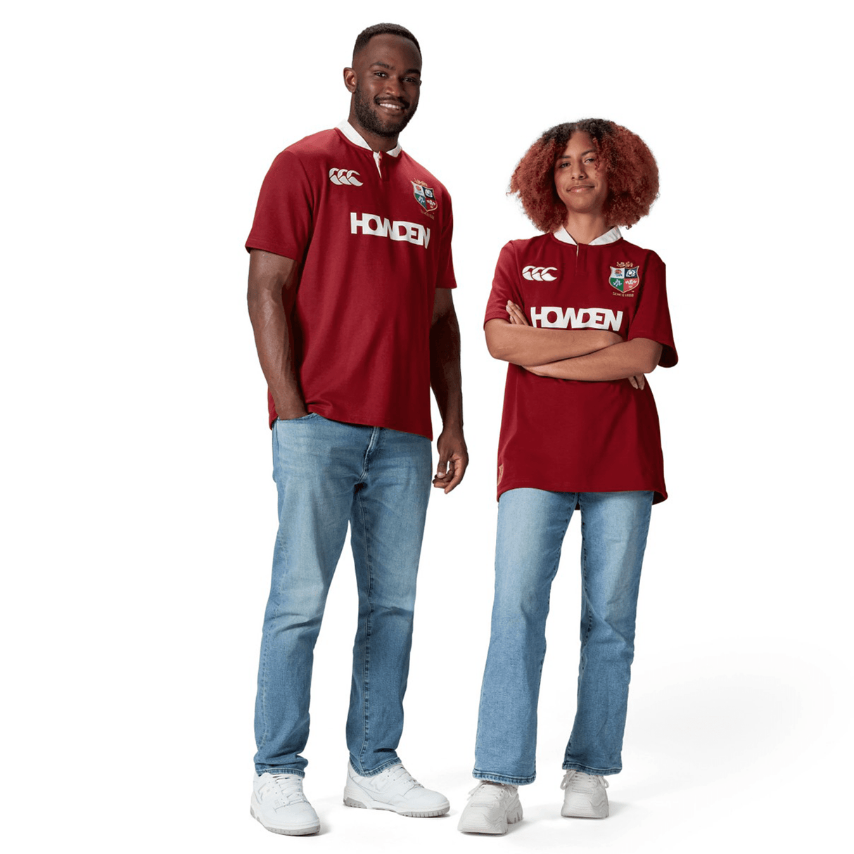 Two people wearing matching British & Irish Lions 2025 Classic Jerseys by Canterbury, styled with blue jeans and white sneakers, stand against a crisp white background.