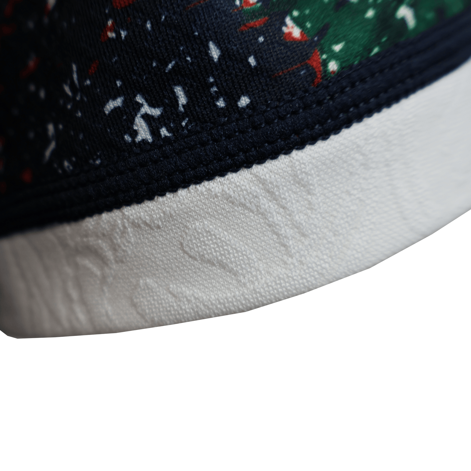 Close-up of the British & Irish Lions 2025 Replica Warm Up Jersey by Canterbury featuring a navy and green pattern with small red details above a white textured band, exuding refined style.