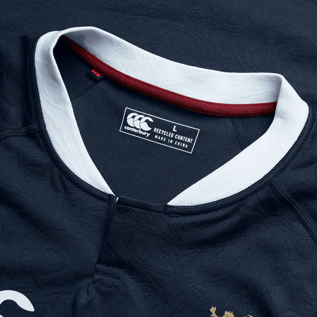 A close-up of the British & Irish Lions 2025 Training Jersey by Canterbury showcases its blue design with white collar details, ergonomically designed panels, and a "L" size label for large. Proudly manufactured in China.