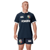 A person wearing a navy athletic outfit, featuring the British & Irish Lions logo on the replica 2025 training jersey and shorts by Canterbury.