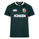 The British & Irish Lions 2025 Training Jersey by Canterbury boasts a green design featuring the "HOWDEN" logo on the front, a white collar, and iconic British & Irish Lions crests. Crafted from recycled polyester, this replica jersey offers style and sustainability for fans passionate about rugby and environmental preservation.