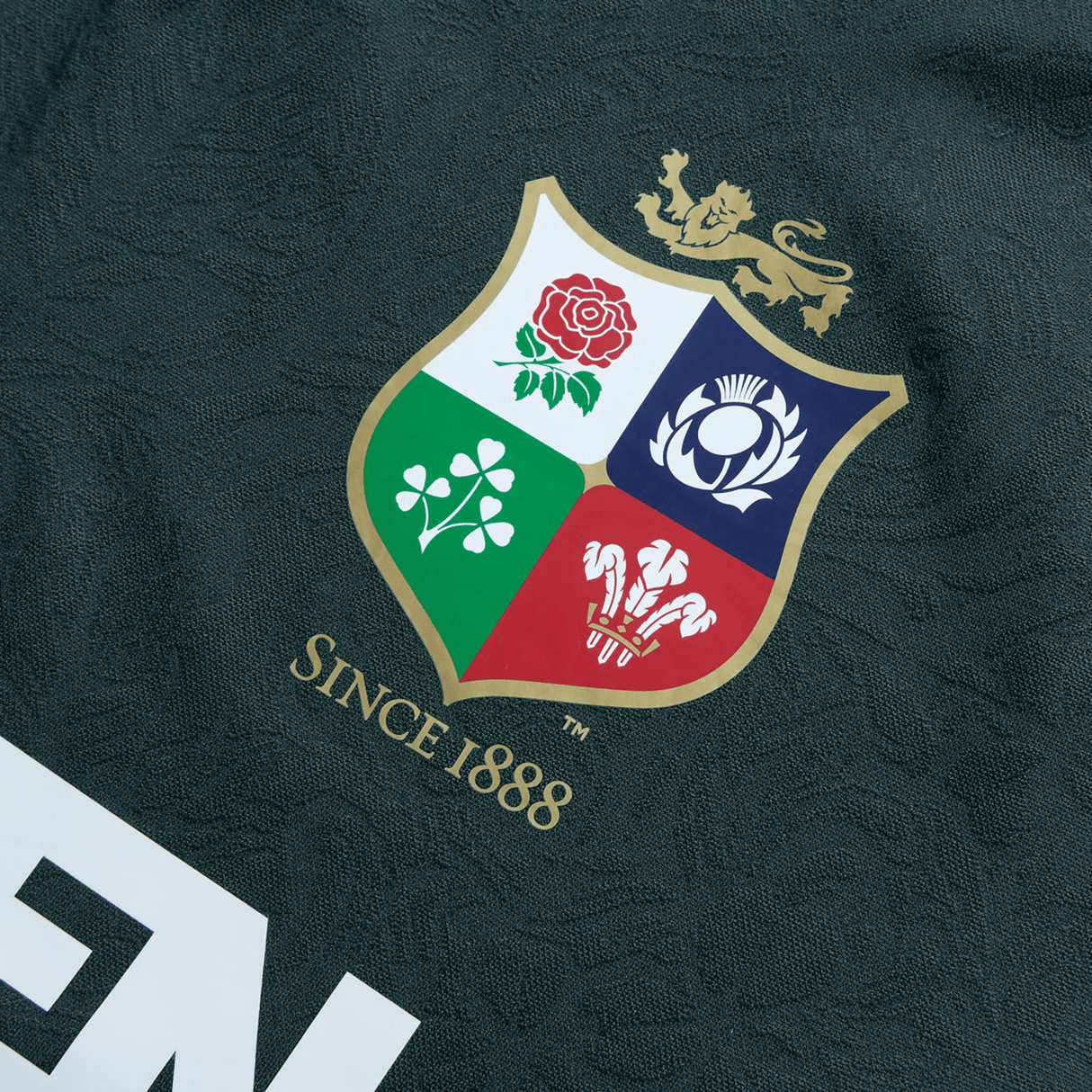 Close-up of the British & Irish Lions 2025 Training Jersey by Canterbury, showcasing a crest with four symbols in its quadrants. The design is made from recycled polyester and includes the text "Since 1888" below.