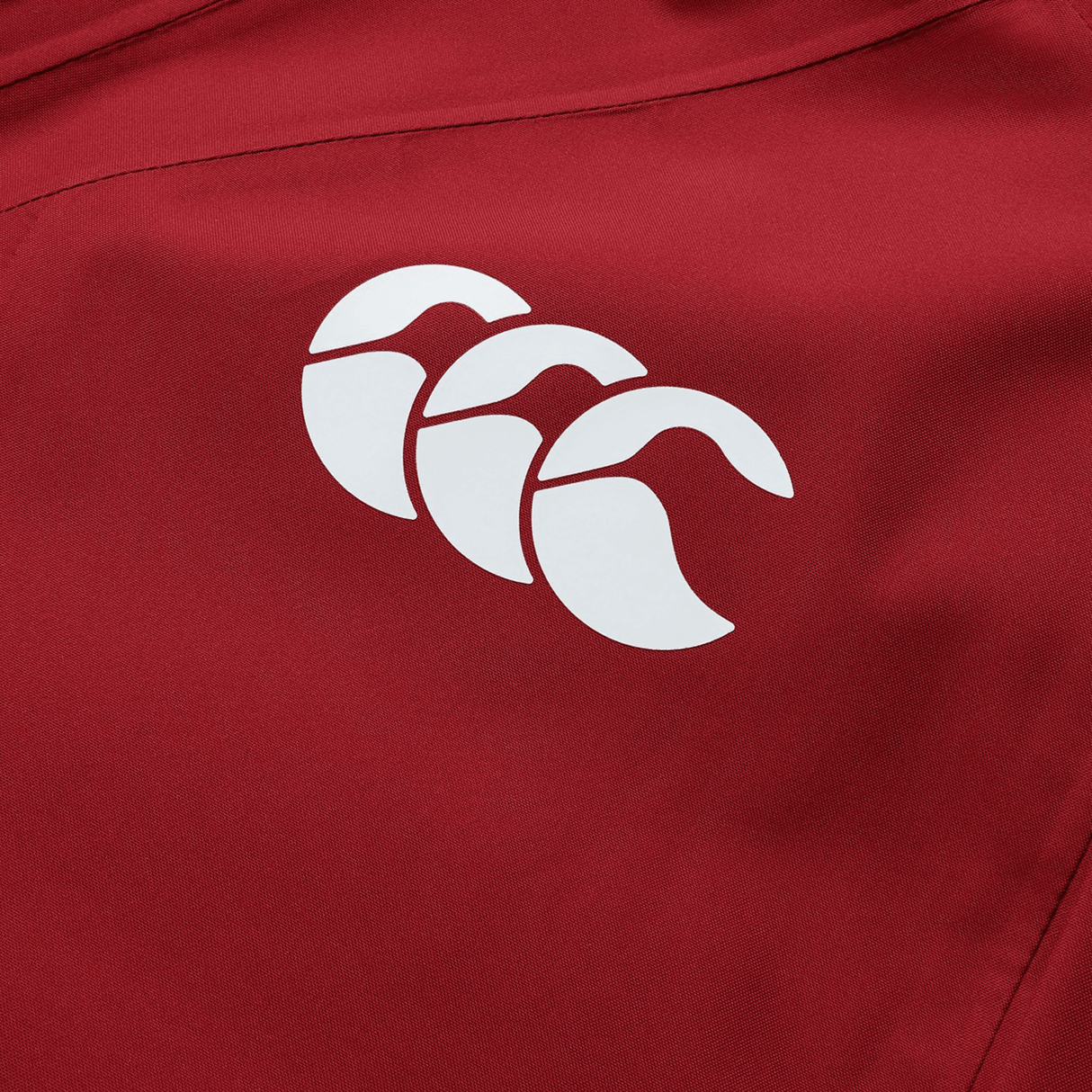 British & Irish Lions 2025 waterproof jacket by Canterbury, made from red polyester fabric and adorned with a white Canterbury logo featuring three stylized overlapping shapes that evoke the iconic British & Irish Lions design.