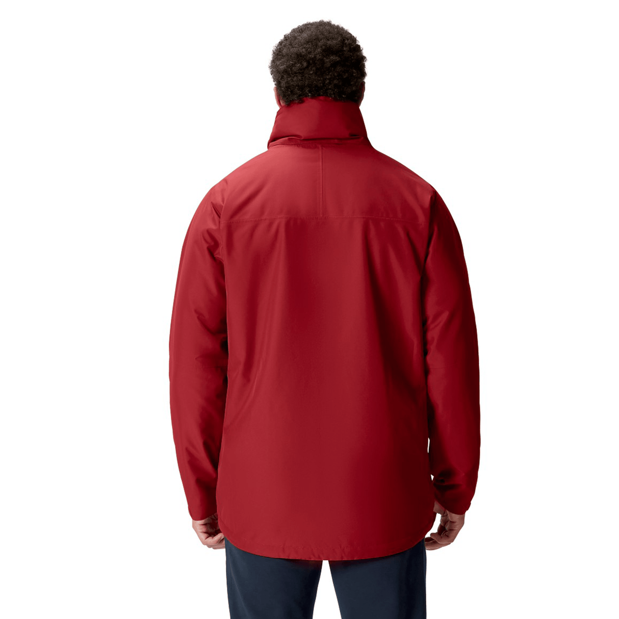 A person wearing a British & Irish Lions 2025 Waterproof Jacket by Canterbury in red, paired with dark pants, is shown from the back against a plain background.