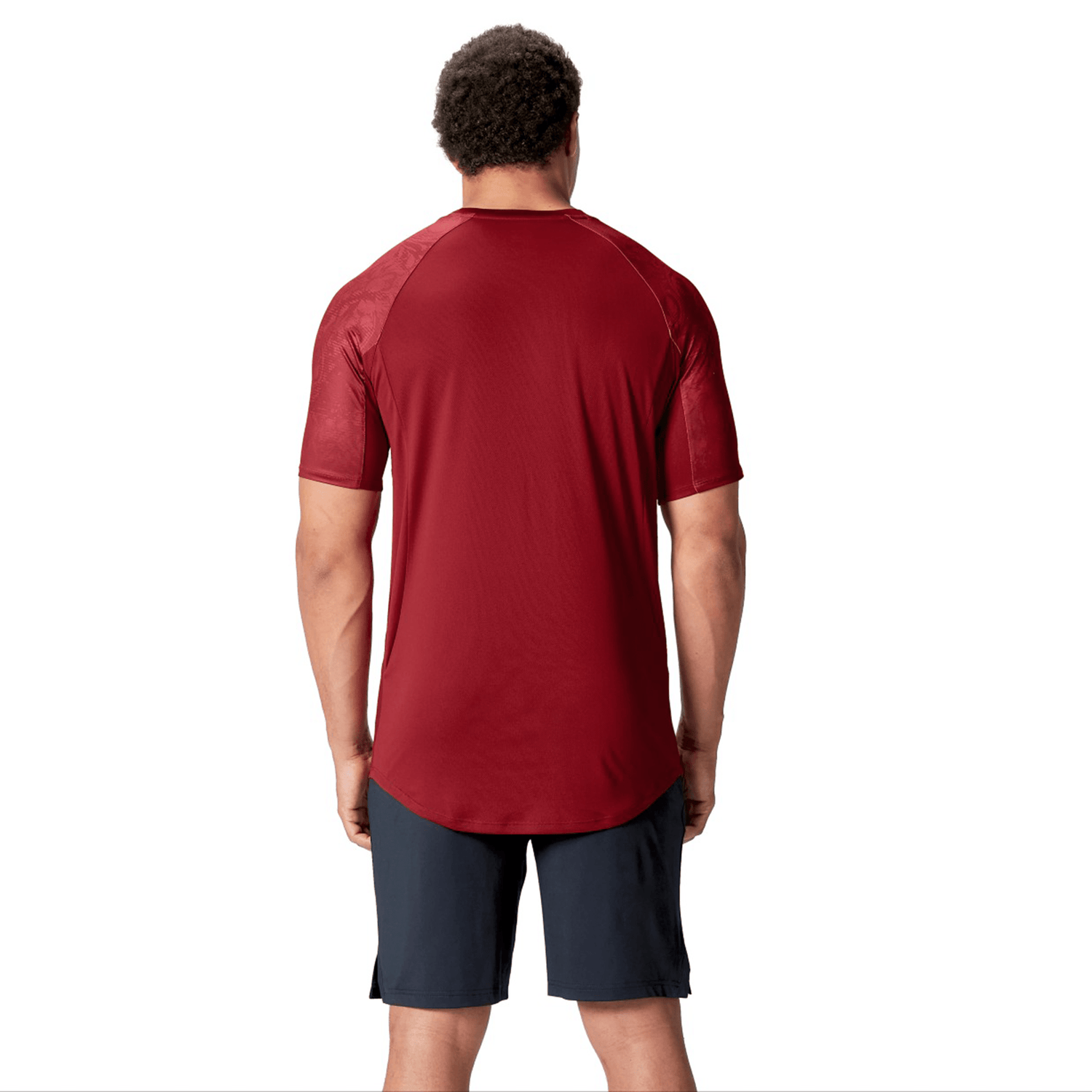 A person wearing a Canterbury British & Irish Lions 25 Superlight Training Tee and dark shorts stands facing away against a plain white background.