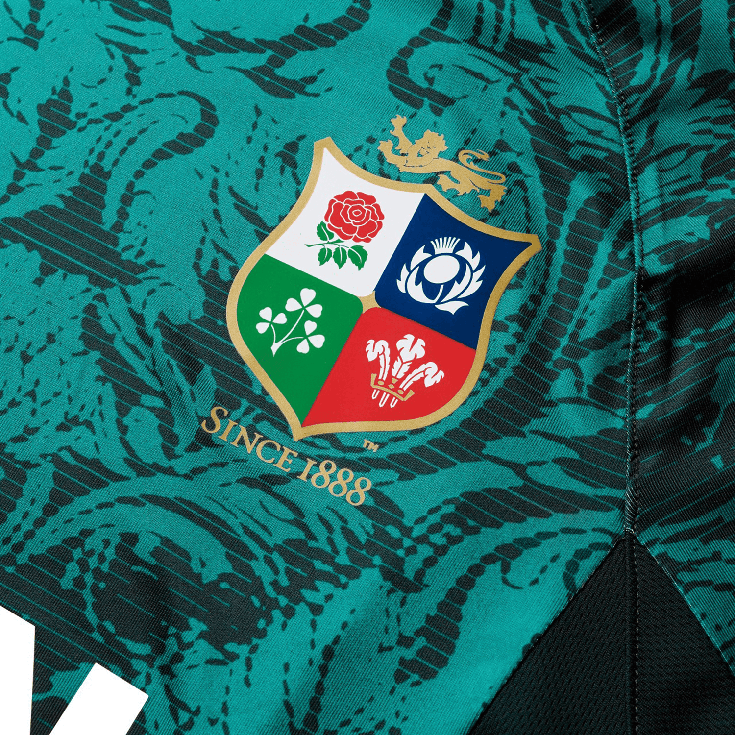 Close-up of the British & Irish Lions 25 Superlight Training Tee by Canterbury in teal, featuring the renowned British & Irish Lions emblem adorned with a rose, thistle, shamrock, and leek, along with the text "Since 1888.