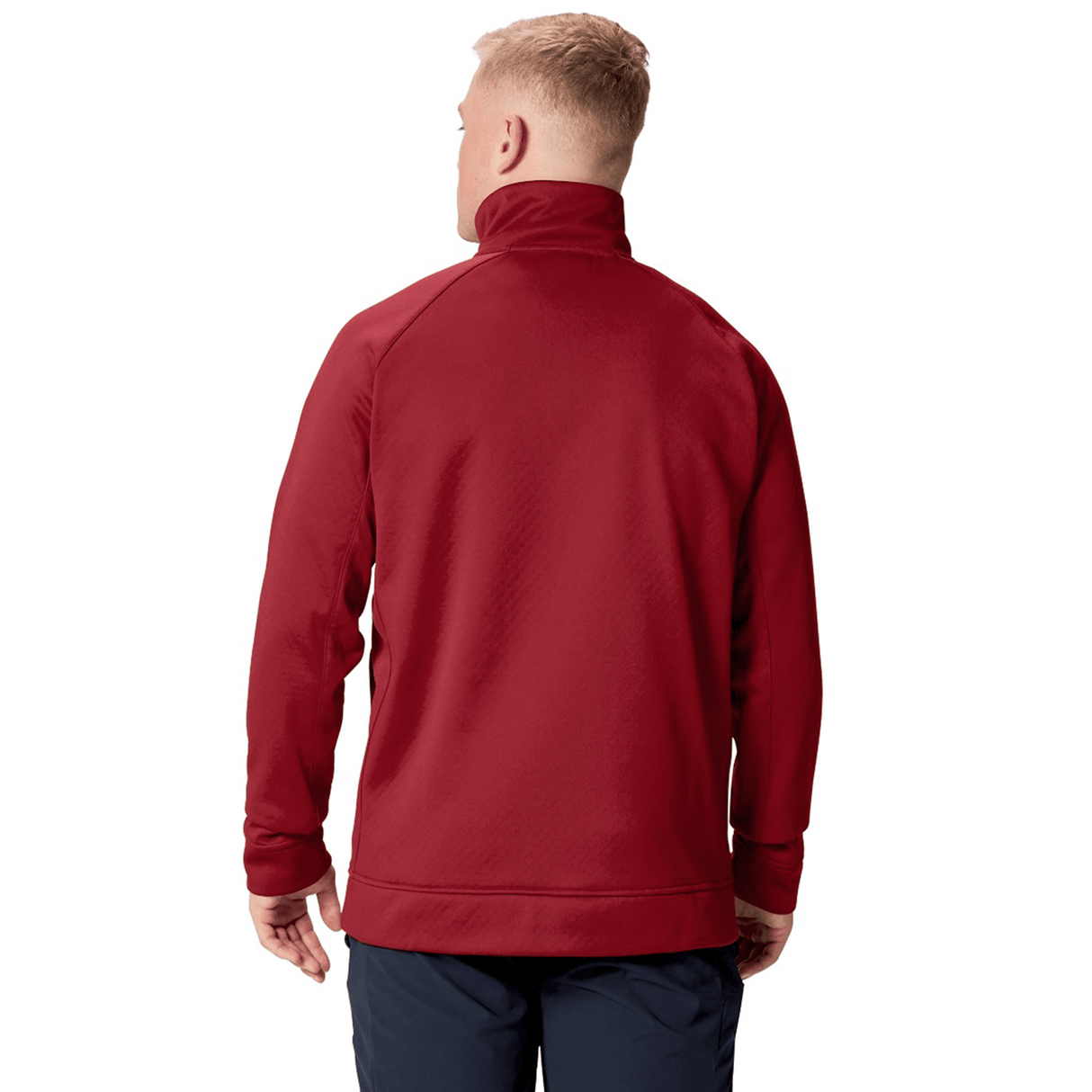 A person with short blond hair is wearing the Canterbury British & Irish Lions 2025 1/4 Zip Fleece in red, paired with dark pants, as they face away from the camera.