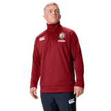 A person wearing the British & Irish Lions 2025 1/4 Zip Fleece by Canterbury stands against a white background, embodying the iconic style of the British & Irish Lions.