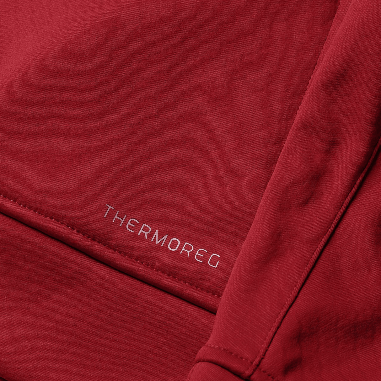 Close-up of red fabric from the British & Irish Lions 2025 1/4 Zip Fleece by Canterbury, featuring "THERMOREG" printed in small white letters, evocative of high-performance gear preferred by the British & Irish Lions.