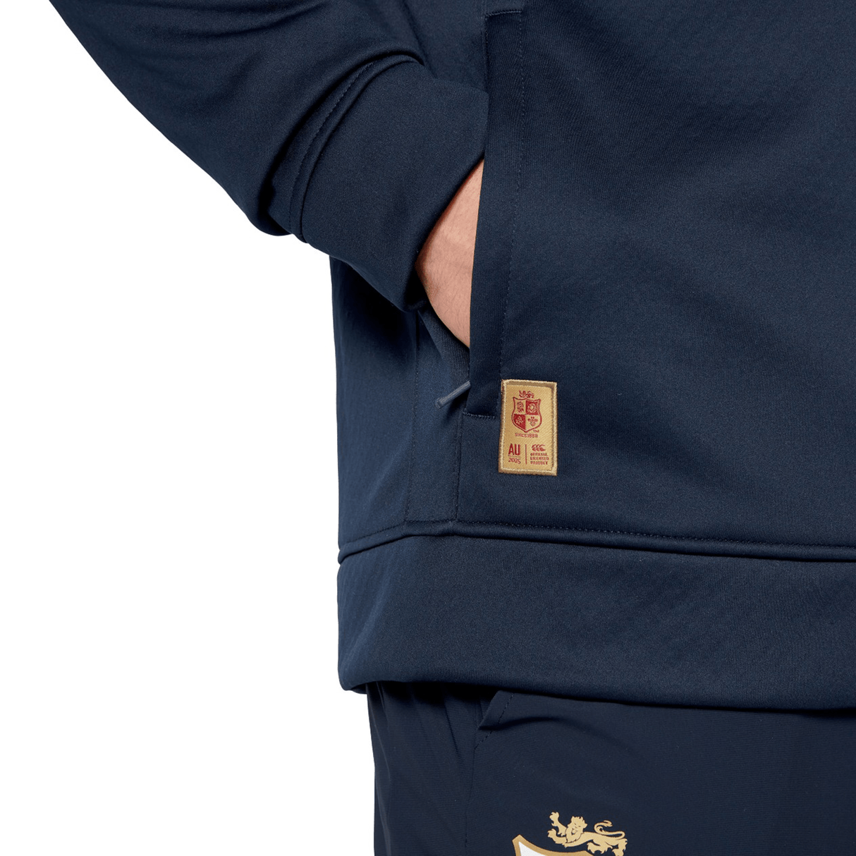 Someone wearing the British & Irish Lions 2025 1/4 Zip Fleece by Canterbury, hands casually tucked in their pockets, could easily be mistaken for a devoted fan of the Canterbury brand.