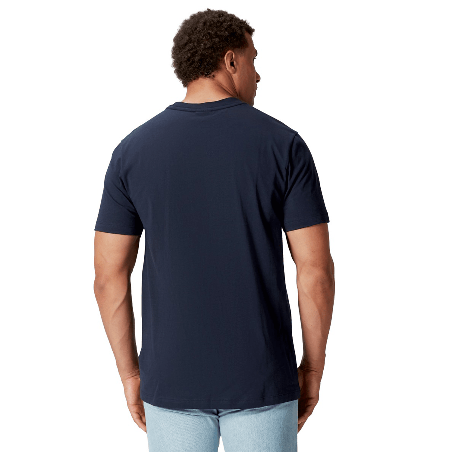 A man in a British & Irish Lions 2025 Cotton Jersey Tee by Canterbury and light jeans is viewed from the back, standing against a white background.