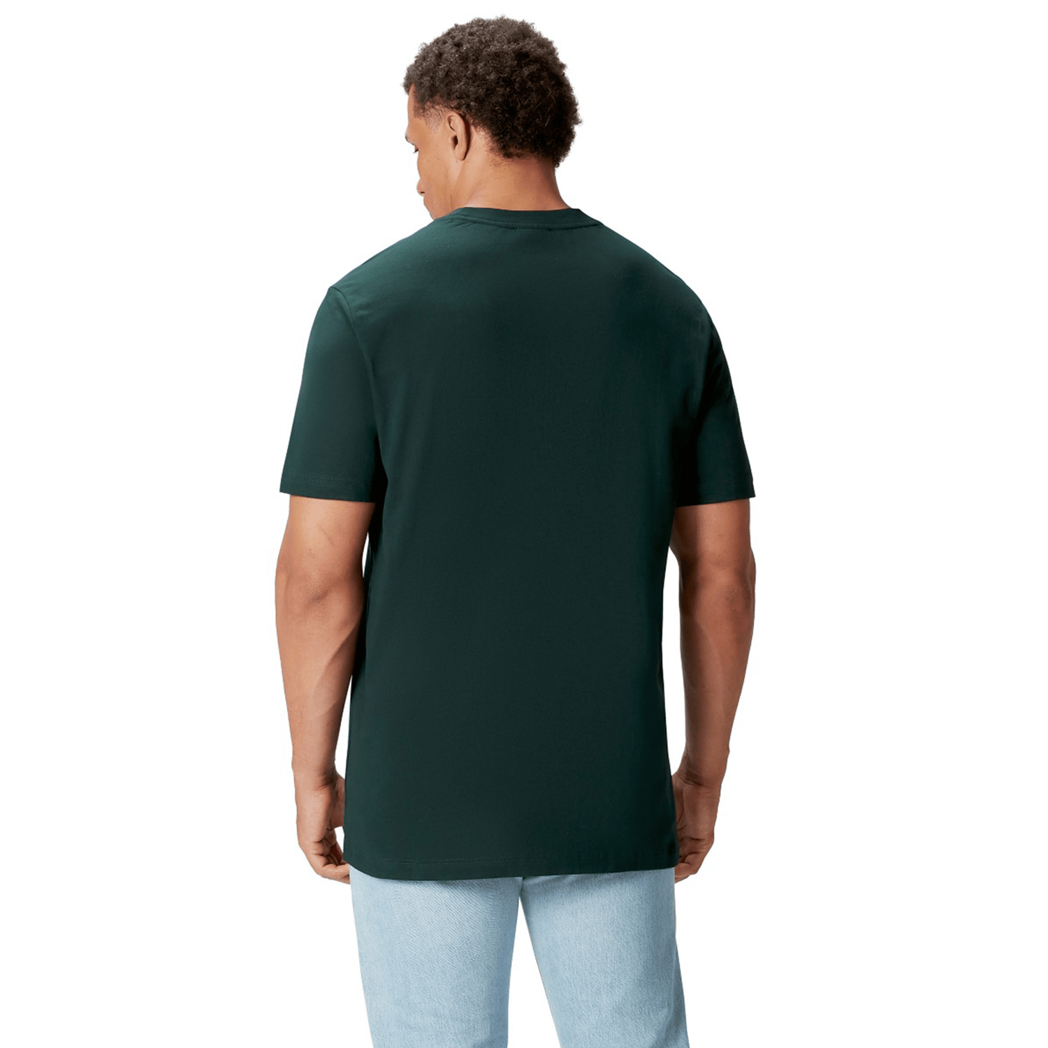 A rugby supporter stands with their back to the camera, wearing a British & Irish Lions 2025 Cotton Jersey Tee by Canterbury in dark green and light blue jeans, set against a plain white background.
