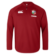 The British & Irish Lions 25 Everest First Layer Top by Canterbury is a red sports top with a quarter zip and logos on the chest, offering a perfect blend of style and performance.