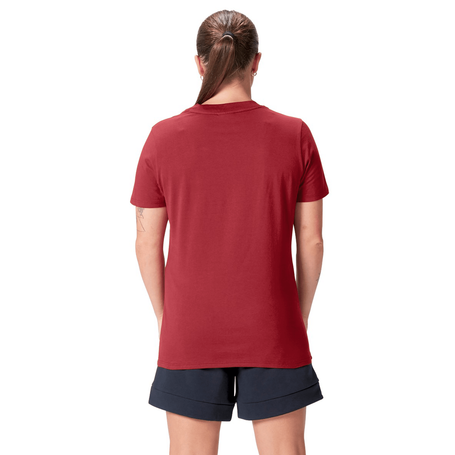 A person facing away, wearing the Canterbury Women's British & Irish Lions 25 Cotton Jersey Tee in red and navy shorts, with hair tied back.