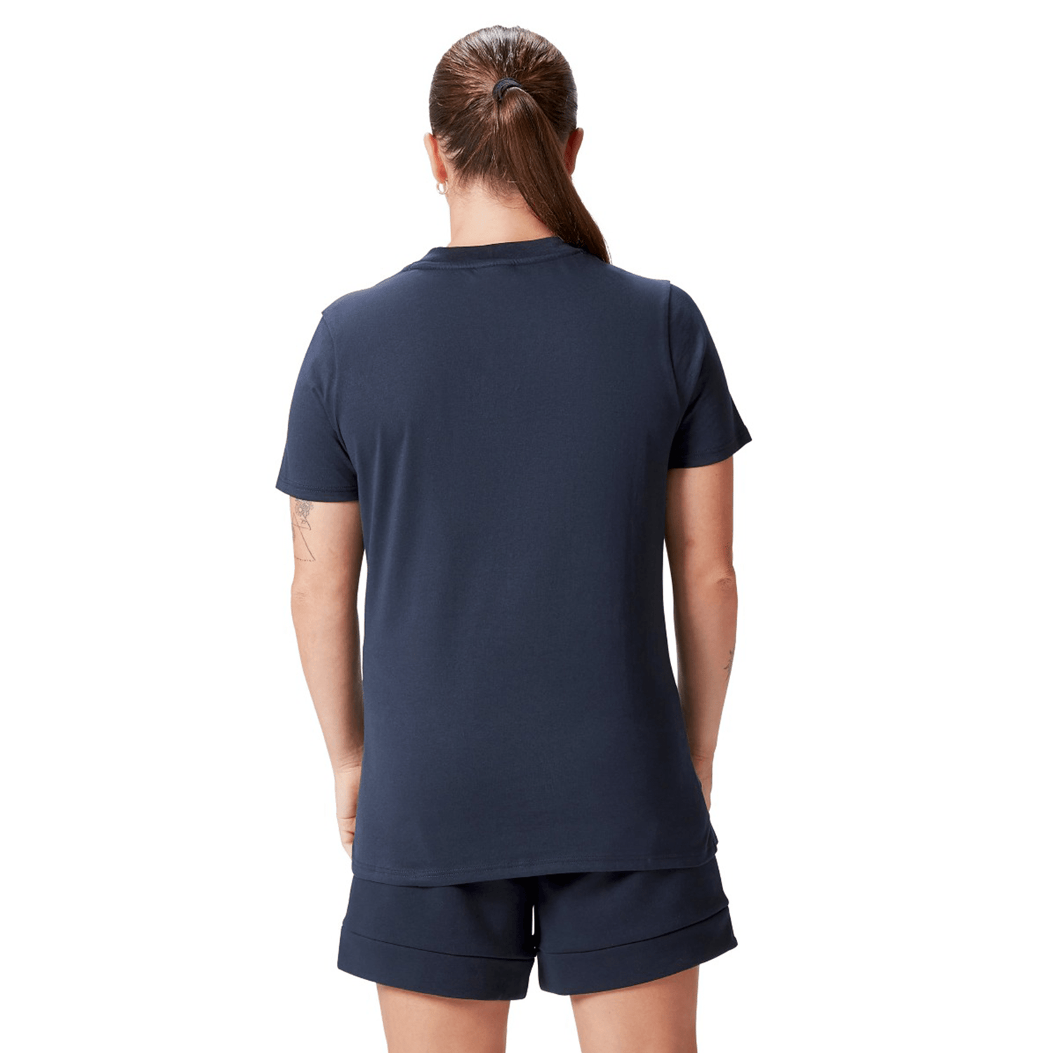 A person with a ponytail, wearing the Women's British & Irish Lions 25 Cotton Jersey Tee by Canterbury and shorts, is seen from the back against a white background.