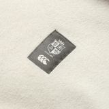 Close-up of a label on a white fabric, featuring Canterbury's iconic shield with "Since 1888" and the three overlapping crescents logo. This detail is perfect for fans of the British & Irish Lions and can be found on your favorite Canterbury British & Irish Lions 2025 Outback Full-Zip Fleece Jacket.