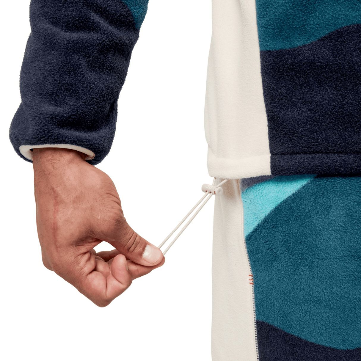 Close-up of a person pulling the drawstring on a blue and white jacket, evocative of the rugged style found in the British & Irish Lions 2025 Outback Full-Zip Fleece Jacket by Canterbury.