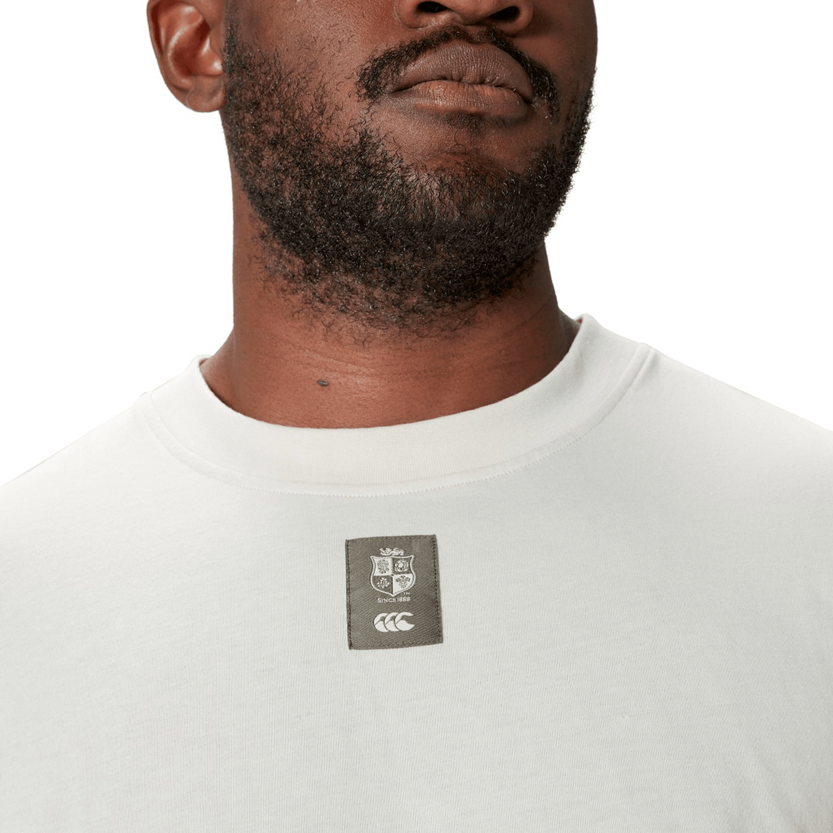 Man wearing the British & Irish Lions 25 Outback Long Sleeve Tee by Canterbury, showcasing a Canterbury logo patch with the British & Irish Lions crest on the chest.
