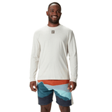 A man wearing a British & Irish Lions 25 Outback Long Sleeve Tee by Canterbury and colorful shorts stands smiling against a white background, evoking the vibrant spirit of the British & Irish Lions.