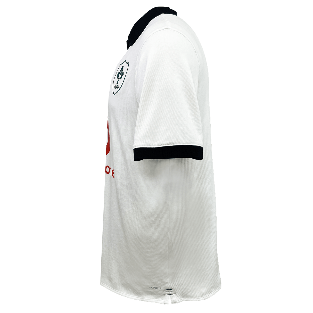 Side view of the lightweight white Ireland 24 Alternate Classic Jersey by Canterbury, showcasing a black collar and sleeve trim. The jersey features a team logo on the chest with a red sponsor logo beneath it, and incorporates VapoDri technology by Canterbury for enhanced comfort.