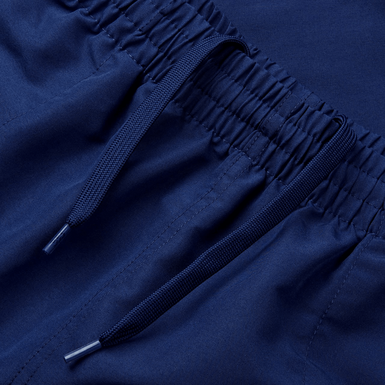 Close-up of the Canterbury Uglies 5" Tactic Short in navy blue, showcasing an elastic waistband, dual drawstrings for adjustment, and deep pockets for convenience.