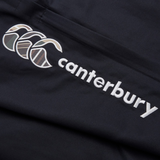 The Canterbury Uglies Cuffed Stadium Pant features a black fabric with a white embroidered Canterbury logo of three overlapping curved shapes, ideal for rugby style enthusiasts or fans appreciating classic sportswear elegance.