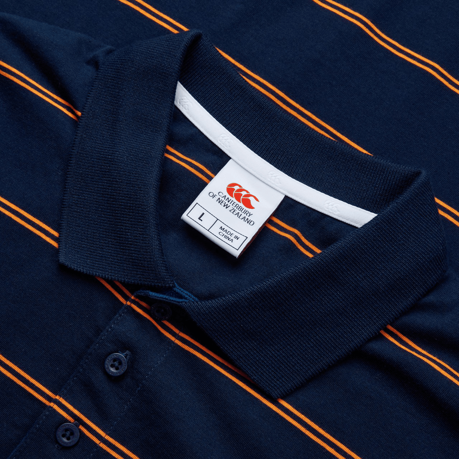 Canterbury's Fundamental Yarn-Dye Stripe Polo in navy blue with orange stripes and a Canterbury label, size L.