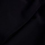 Close-up of the black fabric on the Canterbury Tempo+ 5" 2-In-1 Short, highlighting a diagonal seam running from the bottom left to the top right.